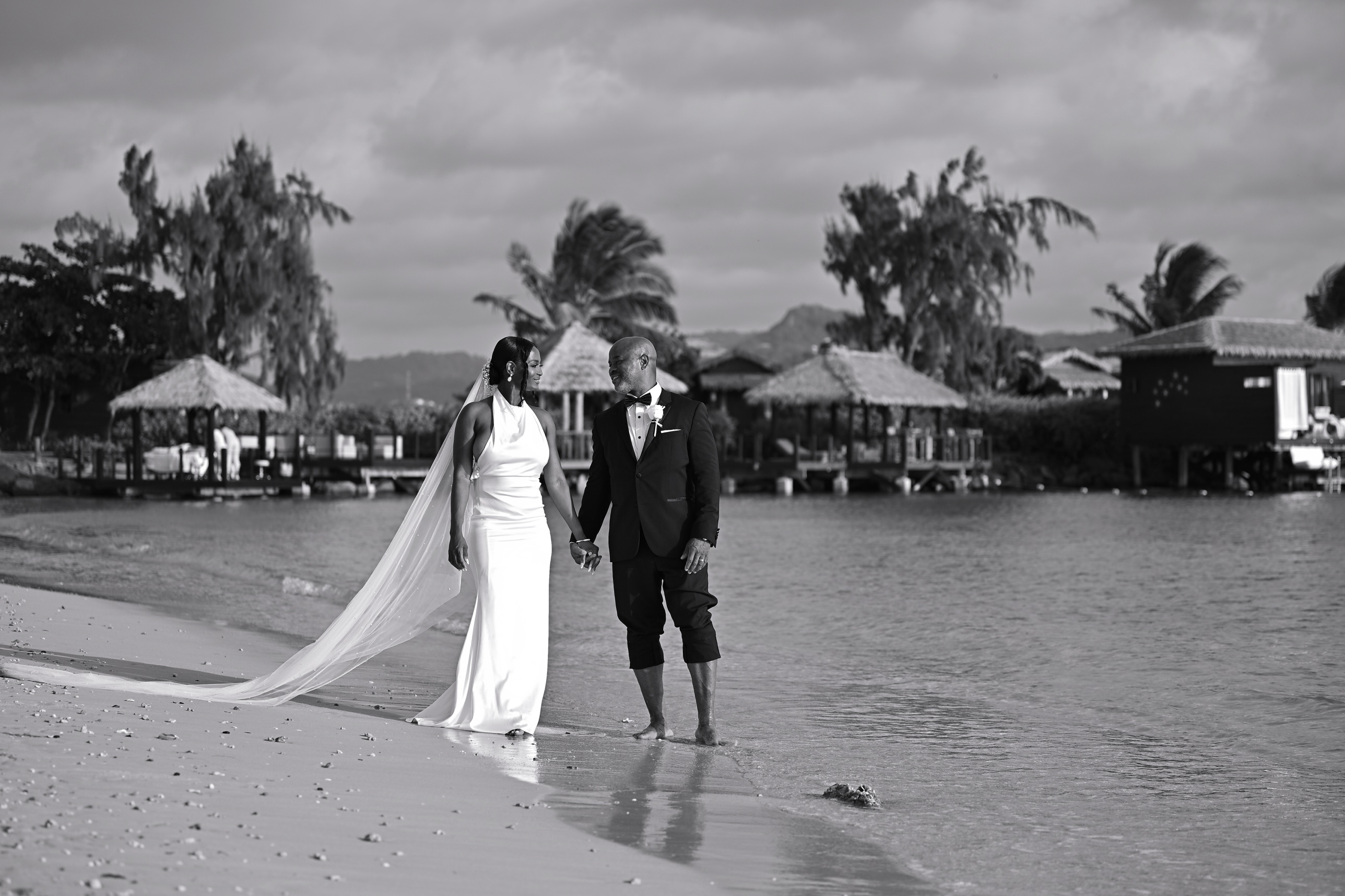 Linda and Charles walking hand in hand along the beach in St. Lucia